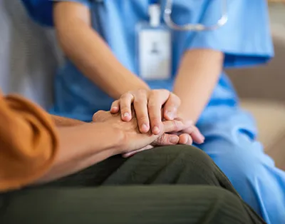 A compassionate provider at a healthcare clinic offering patient support.