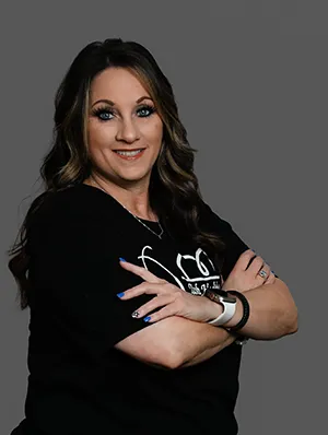 Melissa Martin, M.A., smiling with arms crossed in black t-shirt.